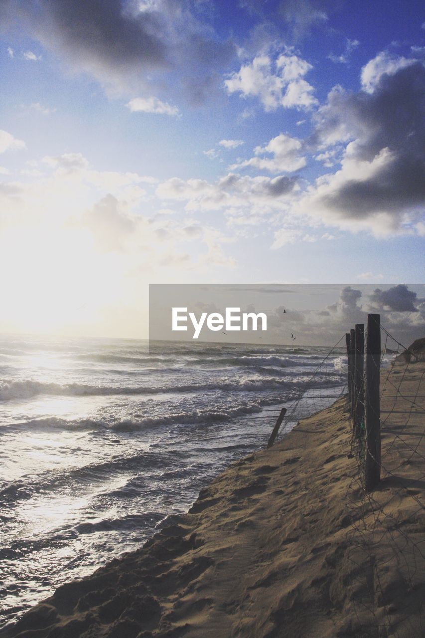 SCENIC VIEW OF BEACH BY SEA AGAINST SKY