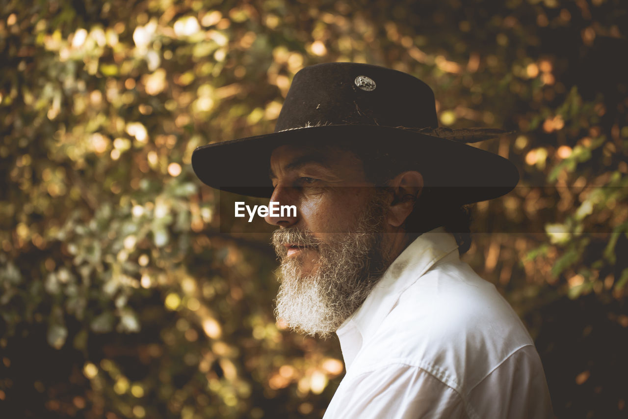 Thoughtful bearded man wearing hat looking away