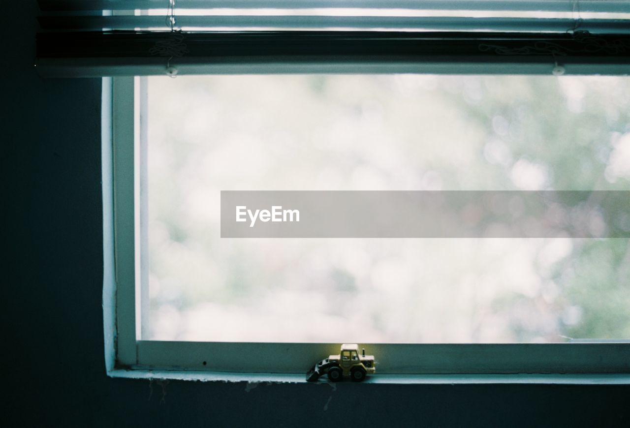 CLOSE-UP OF WINDOW AGAINST SKY