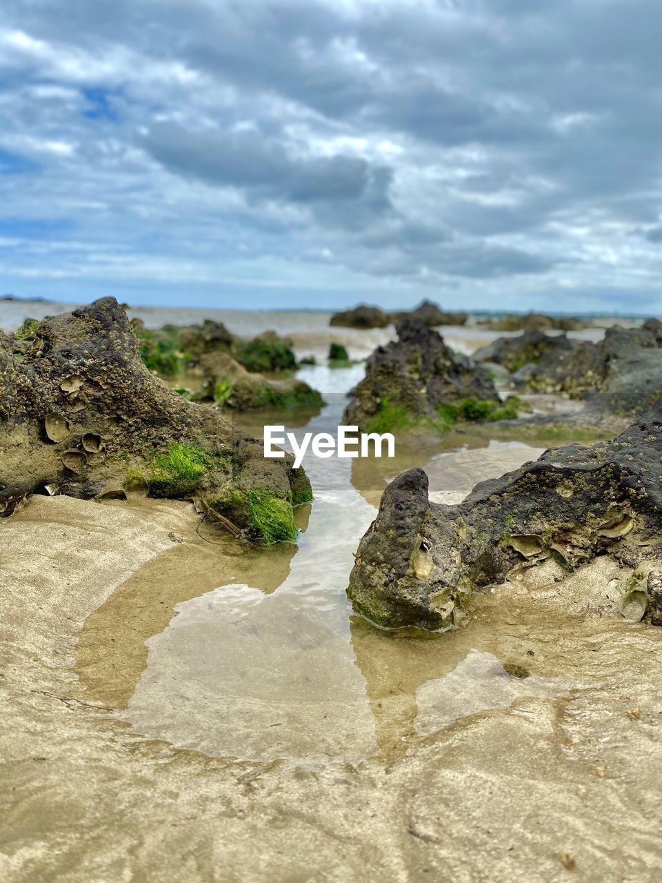 Rocks on beach against sky