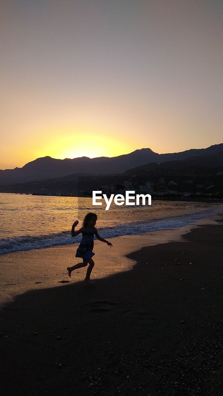 SILHOUETTE MAN ON BEACH DURING SUNSET