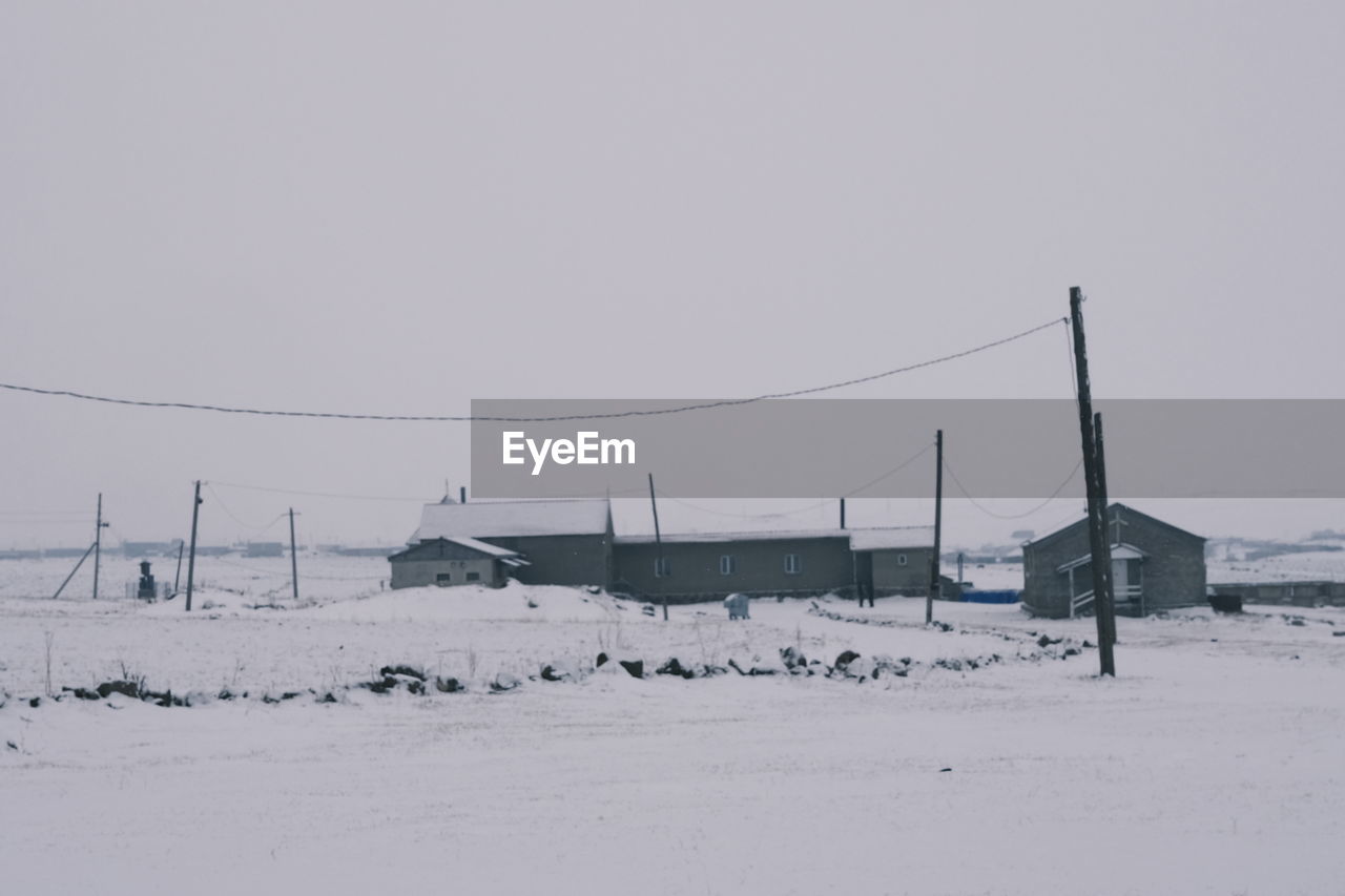 SNOW COVERED FIELD AGAINST SKY