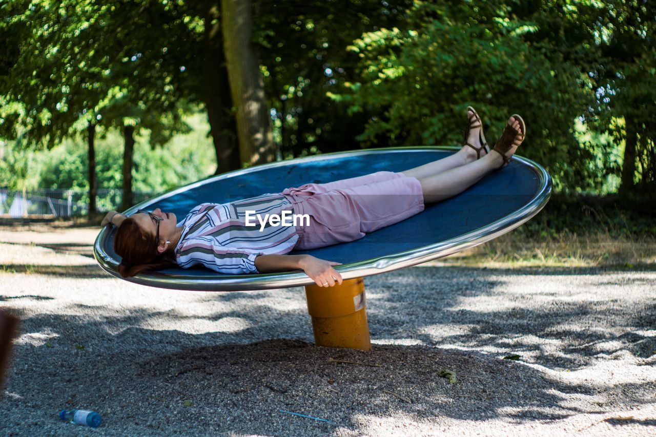 Girl is playing on a rotating wheel