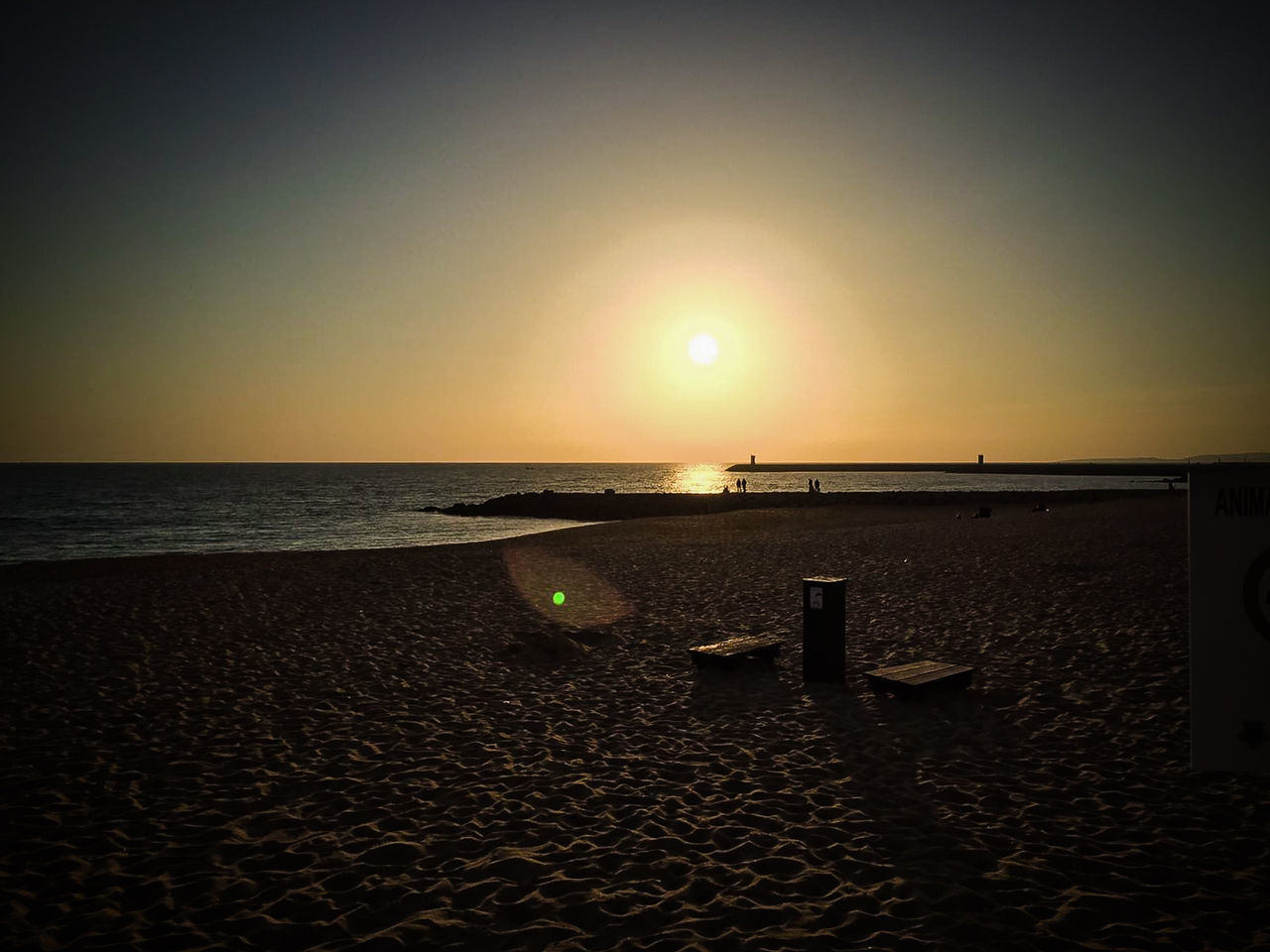 SCENIC VIEW OF BEACH AGAINST SKY AT SUNSET