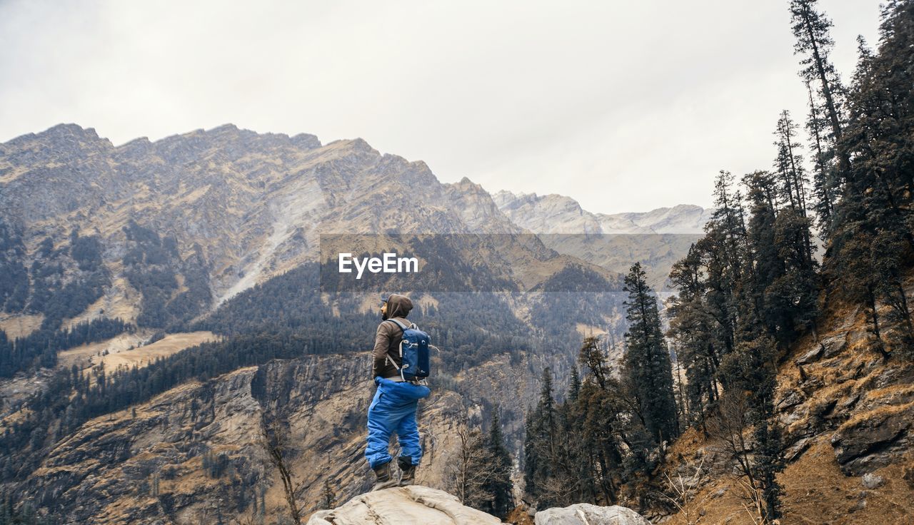 Man standing on mountain against sky