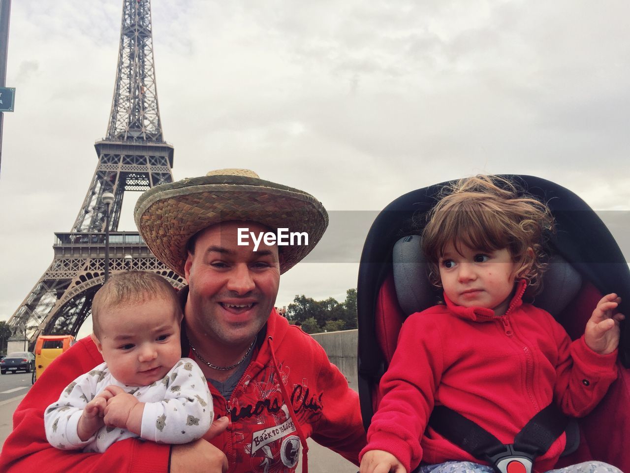 Portrait of happy father with his children with eiffel tower in background