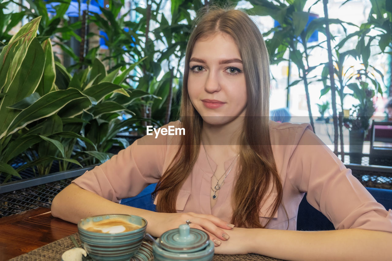 Portrait of young woman at cafe