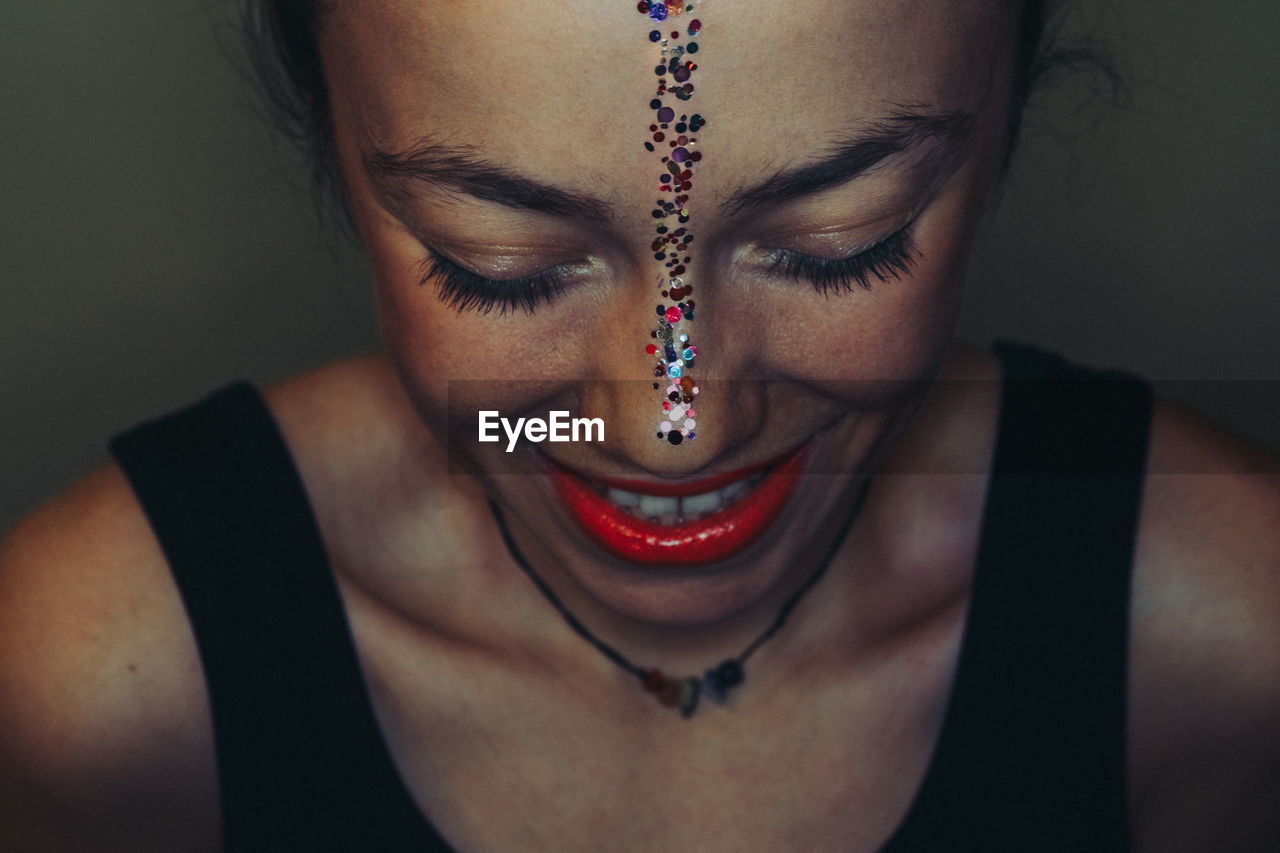 Close-up of smiling woman wearing make-up