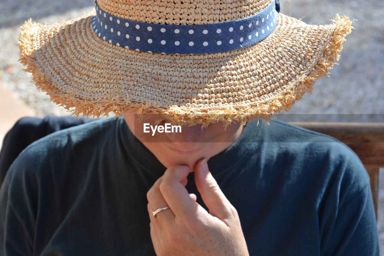Close-up of man wearing sun hat