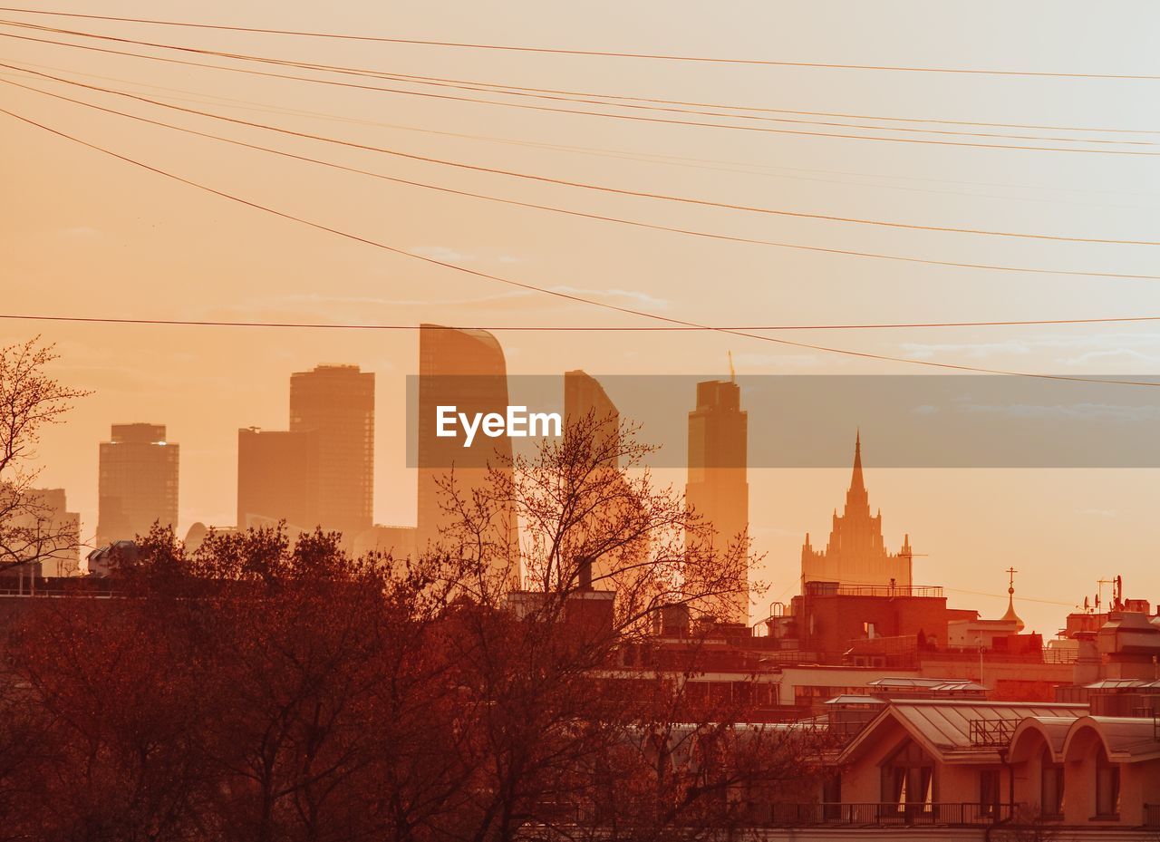 BUILDINGS AGAINST SKY AT SUNSET