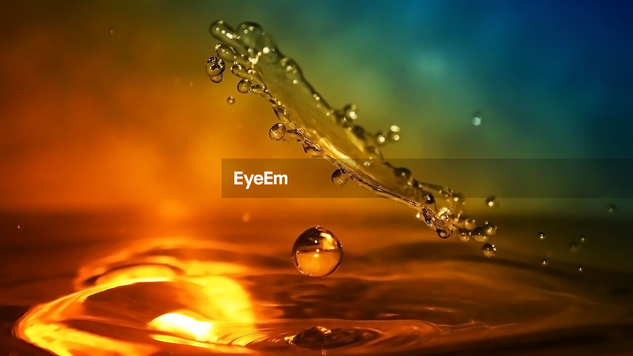 CLOSE-UP OF WATER SPLASHING AGAINST SKY