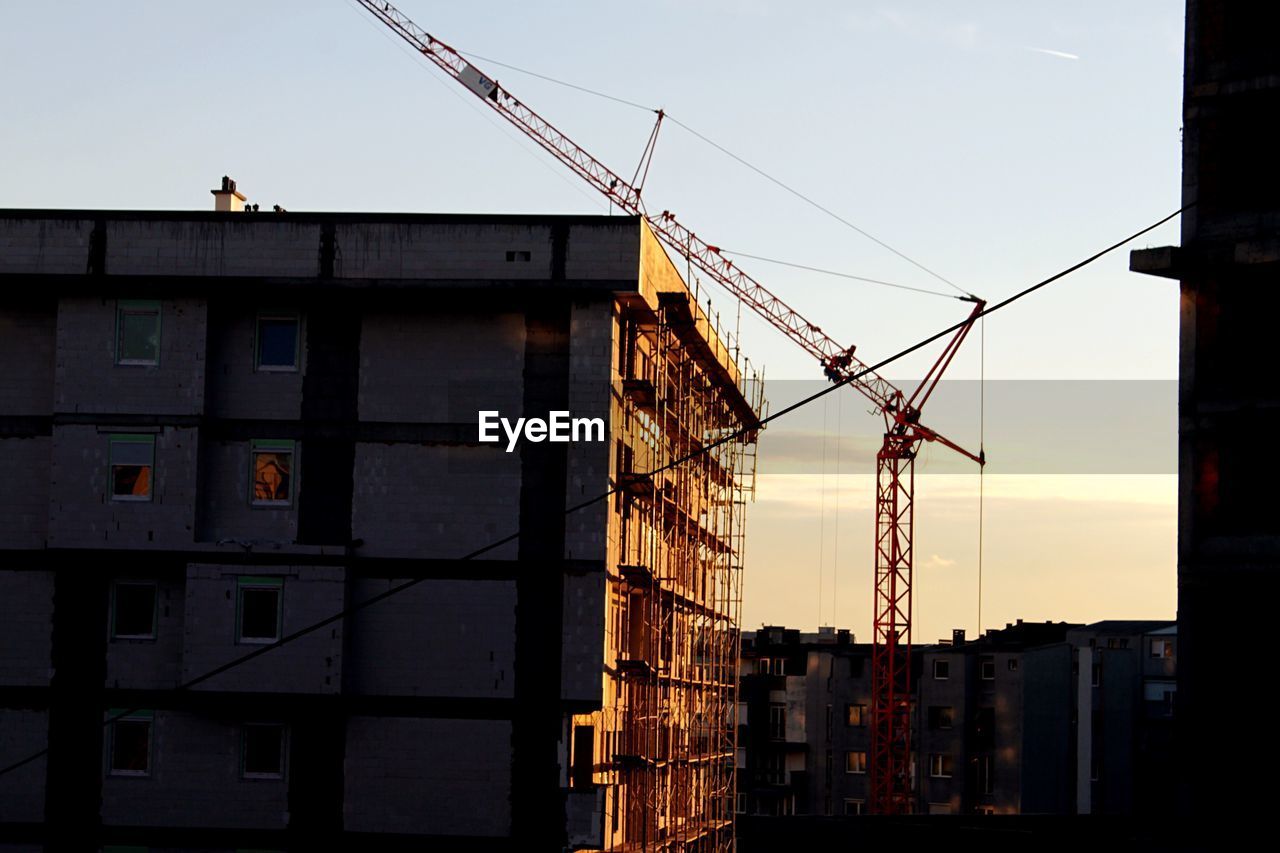 CRANES AT CONSTRUCTION SITE