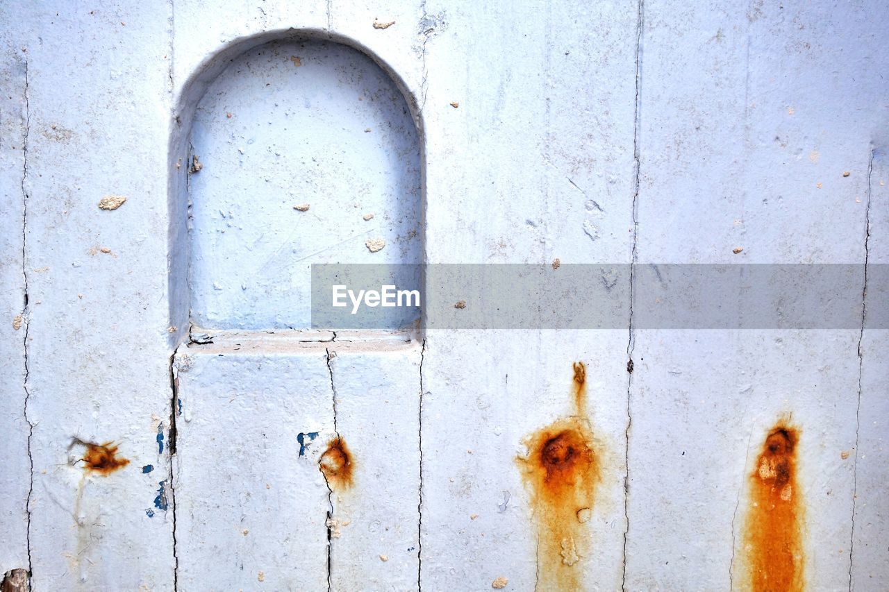 Close-up of niche on white wooden wall