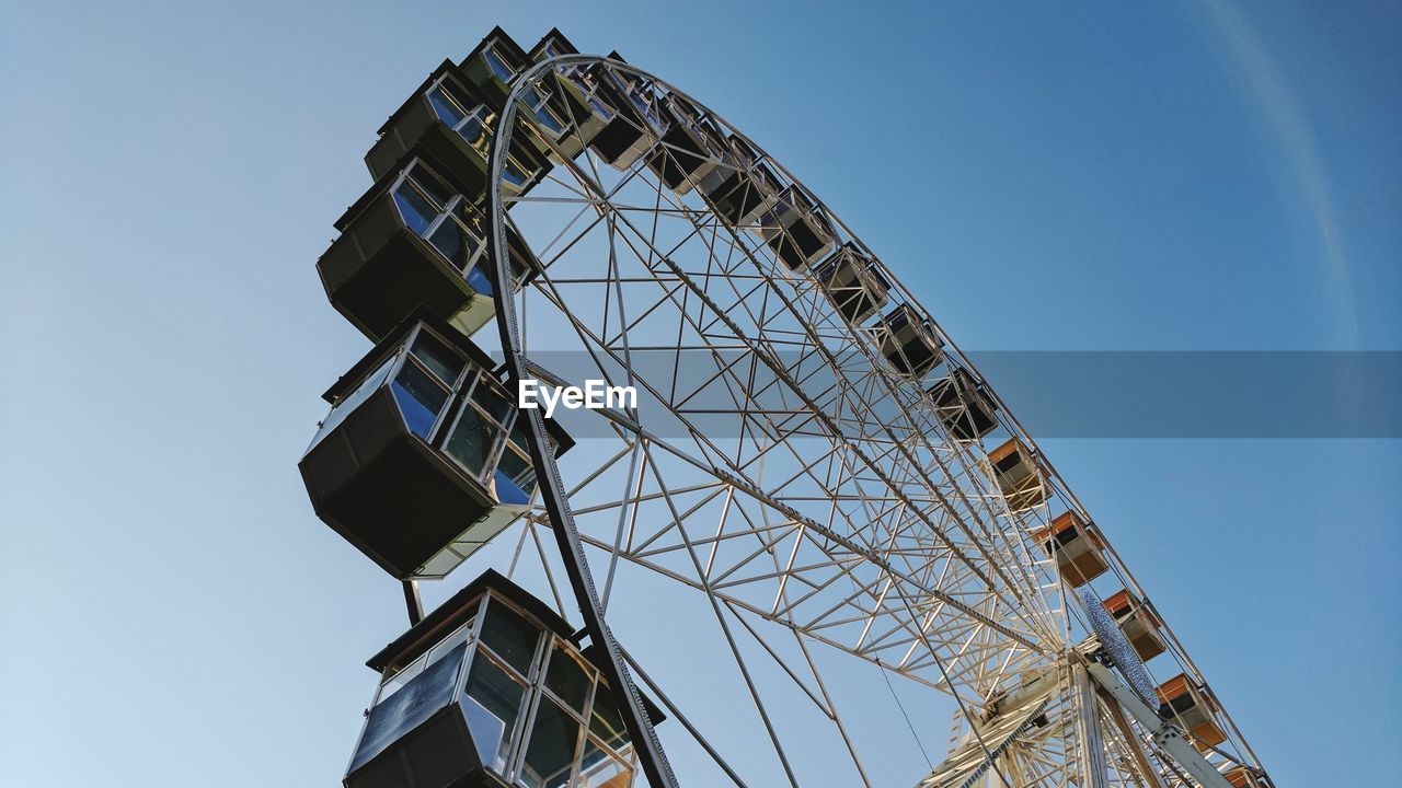 Low angle view of ferris wheel against clear sky