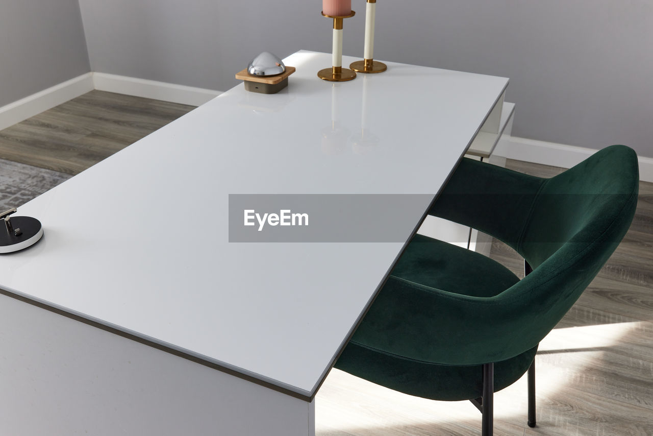 table, furniture, indoors, chair, seat, business, floor, home interior, coffee table, office, no people, wealth, wood, food and drink, technology, luxury, domestic room, lifestyles, meeting