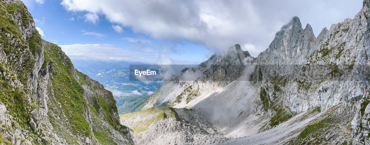 panoramic view of waterfall in forest against sky