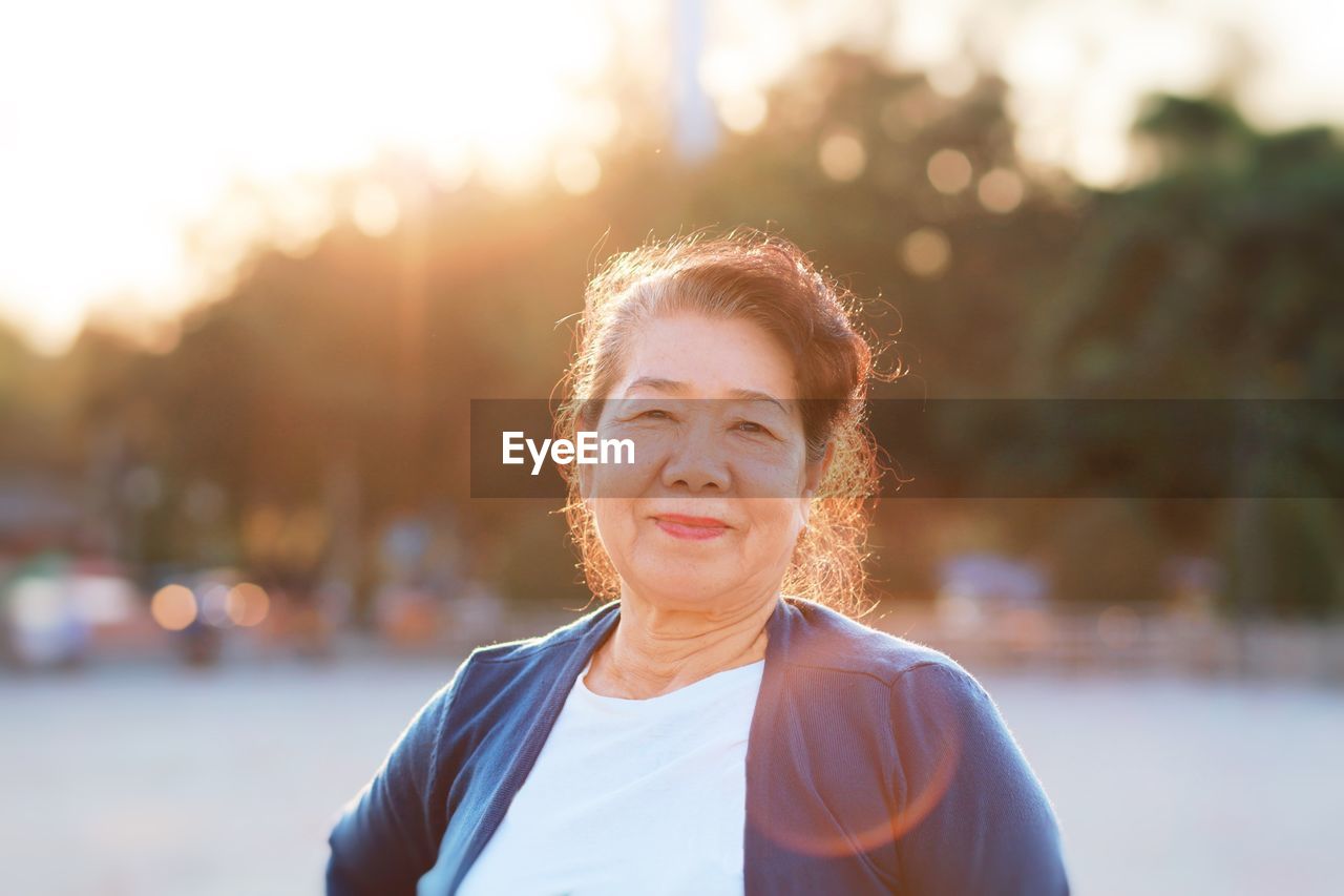 Portrait of smiling senior woman standing outdoors