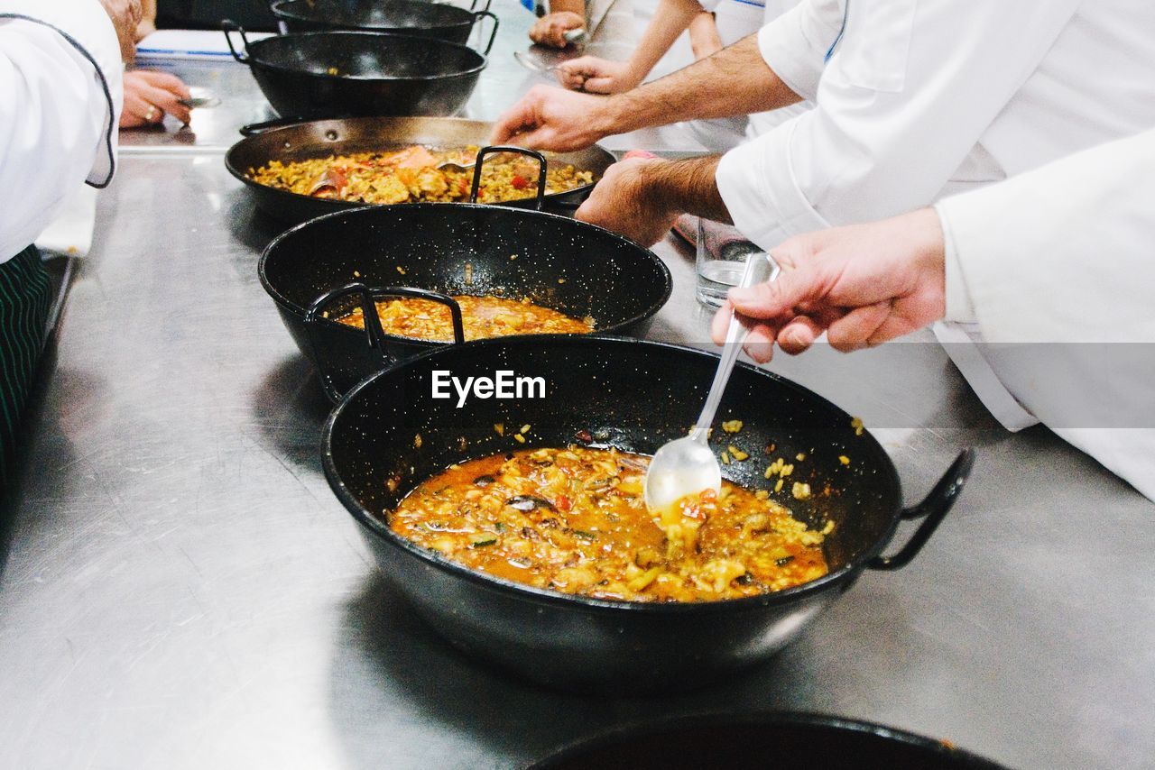 Close-up of men tasting food