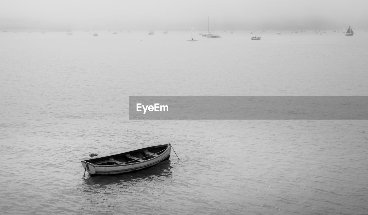 Rowboat on the sea on a foggy morning 