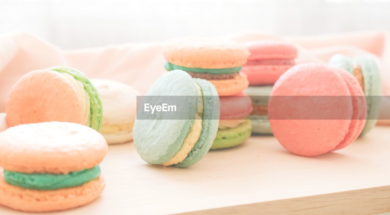 Multicoloured macarons on the wooden tray