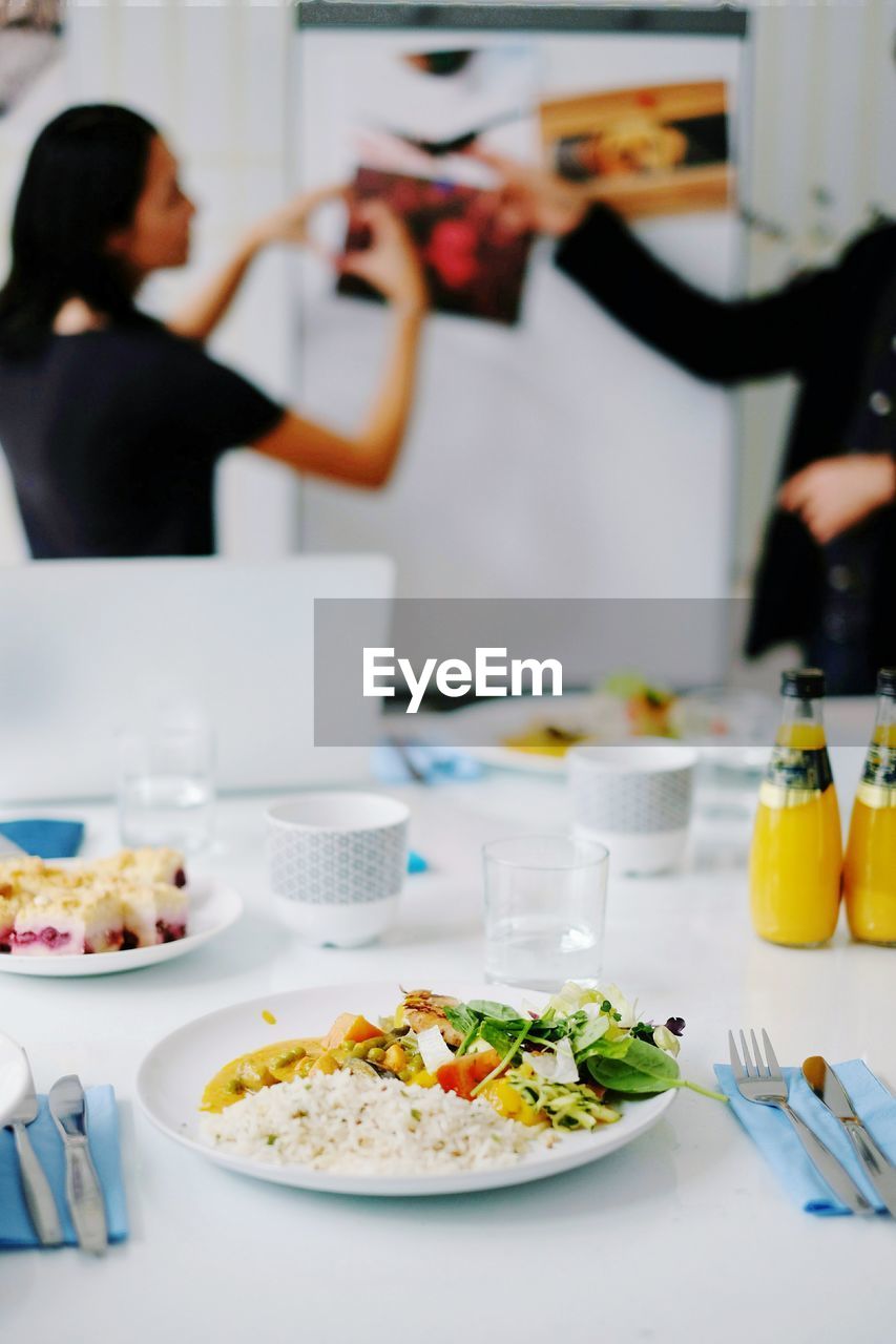 Food served on table and people in background