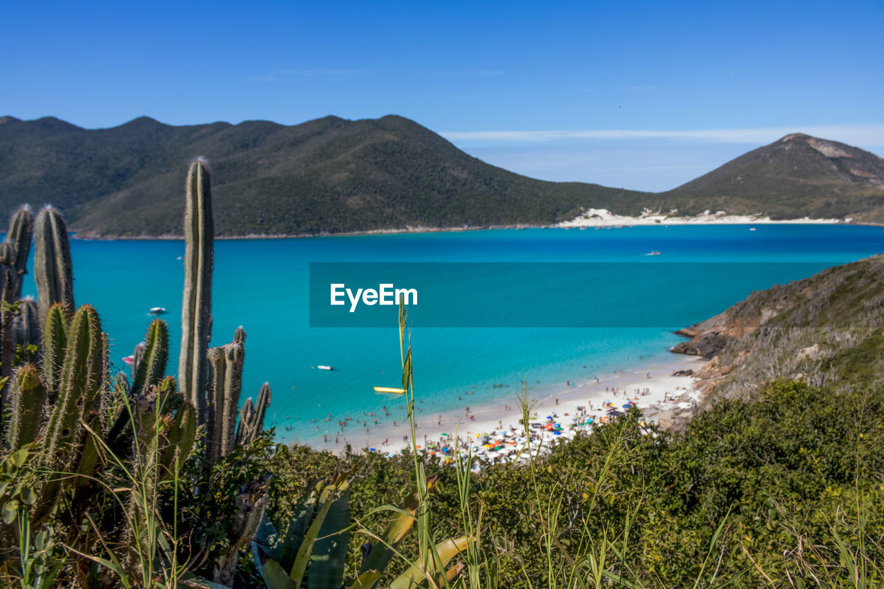Scenic view of sea and mountains against sky