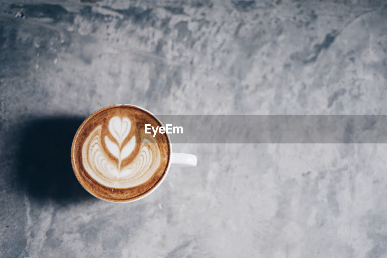 CLOSE-UP OF COFFEE CUP ON TABLE