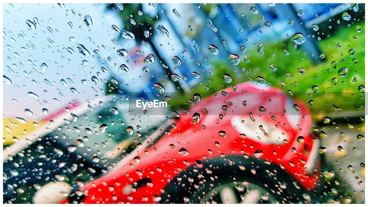 CLOSE-UP OF WATERDROPS ON WINDOW AGAINST SKY