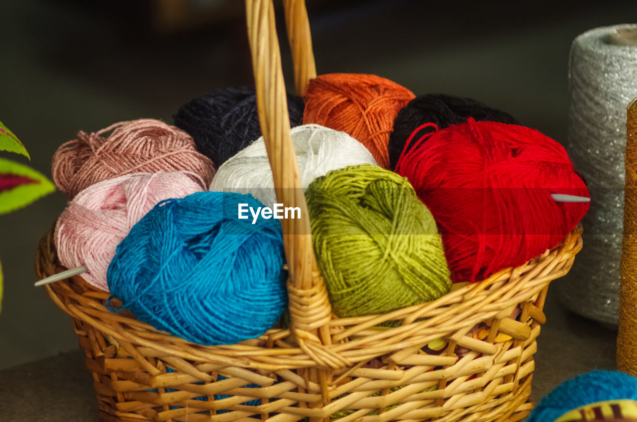 Close-up of colorful wools in wicker basket