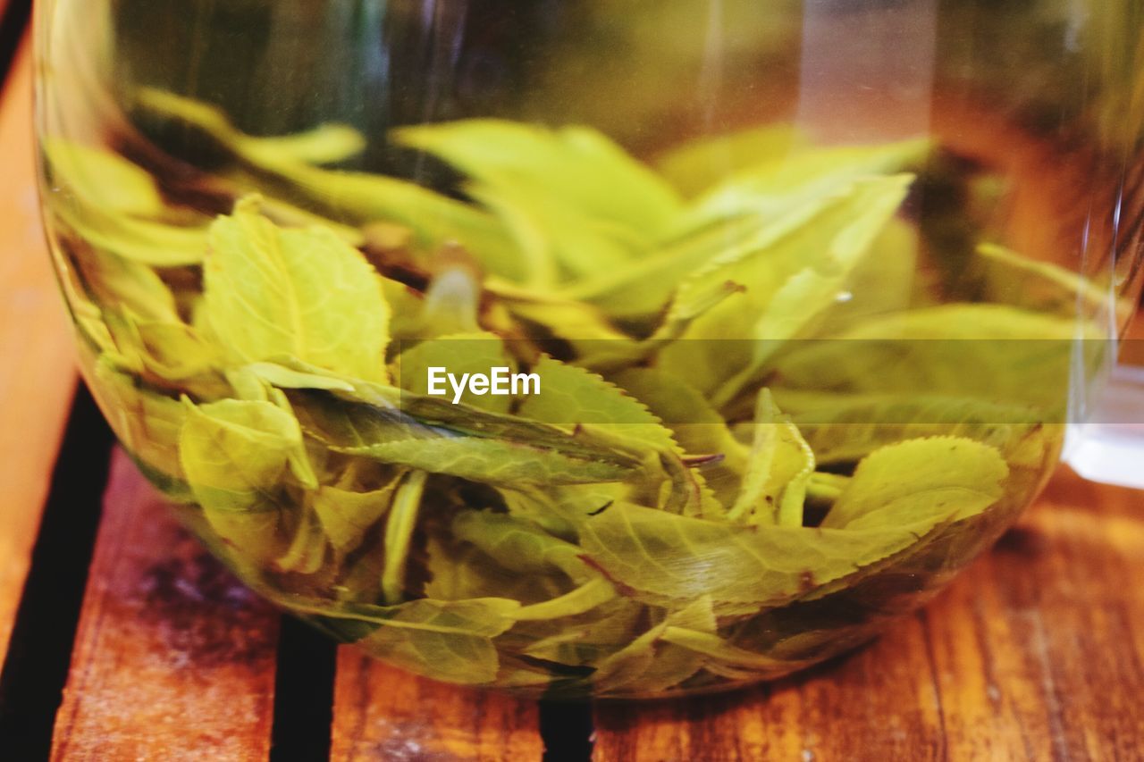 CLOSE-UP OF VEGETABLES IN GLASS ON TABLE