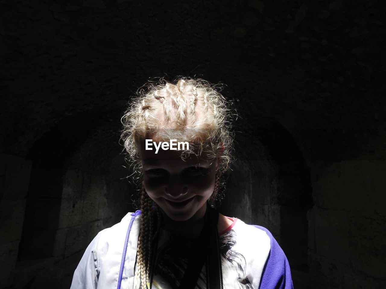 Portrait of smiling girl in tunnel