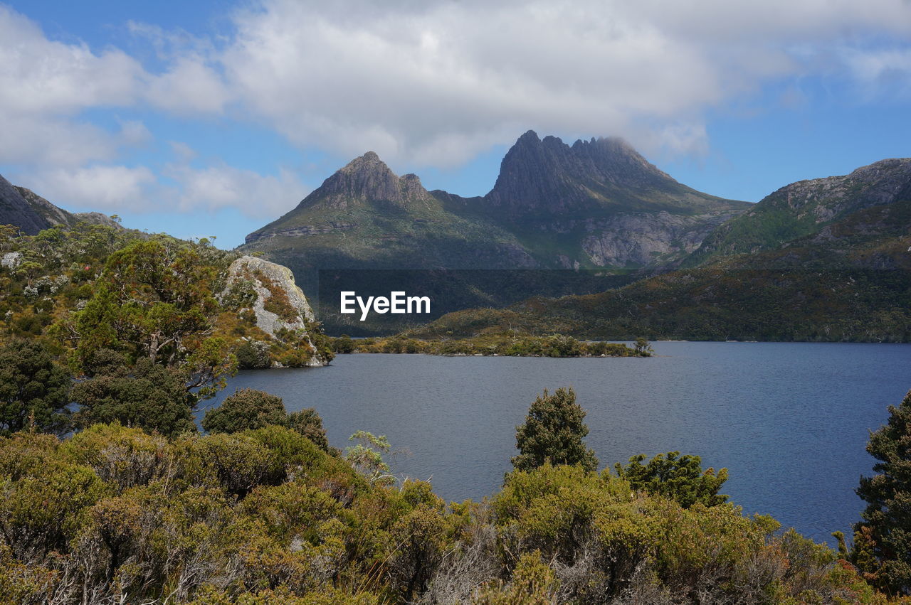 Scenic view of lake and mountains against sky