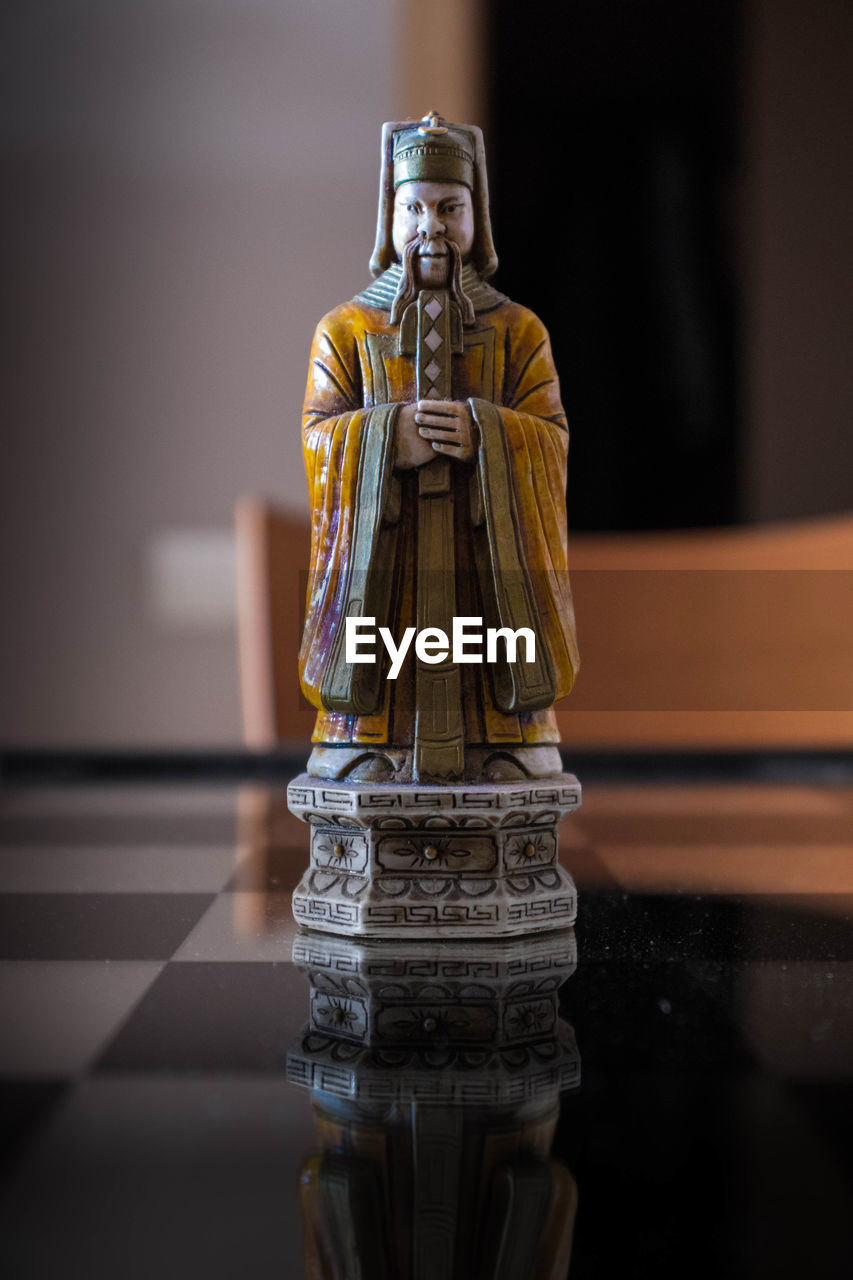 CLOSE-UP OF BUDDHA STATUE AT TEMPLE