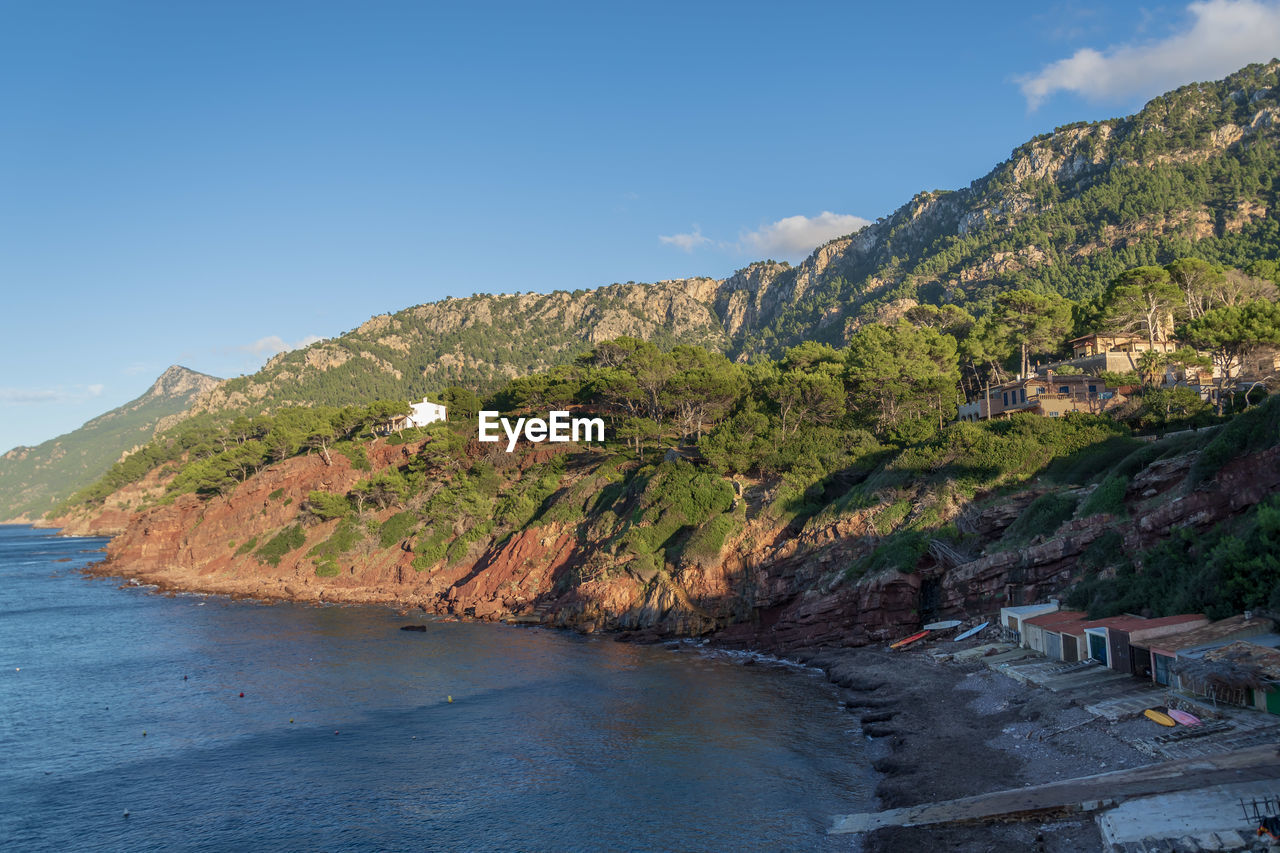 Scenic view of sea and mountains against sky