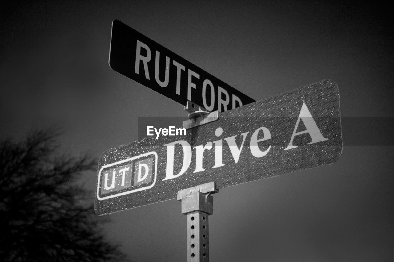 Close-up of information sign against sky