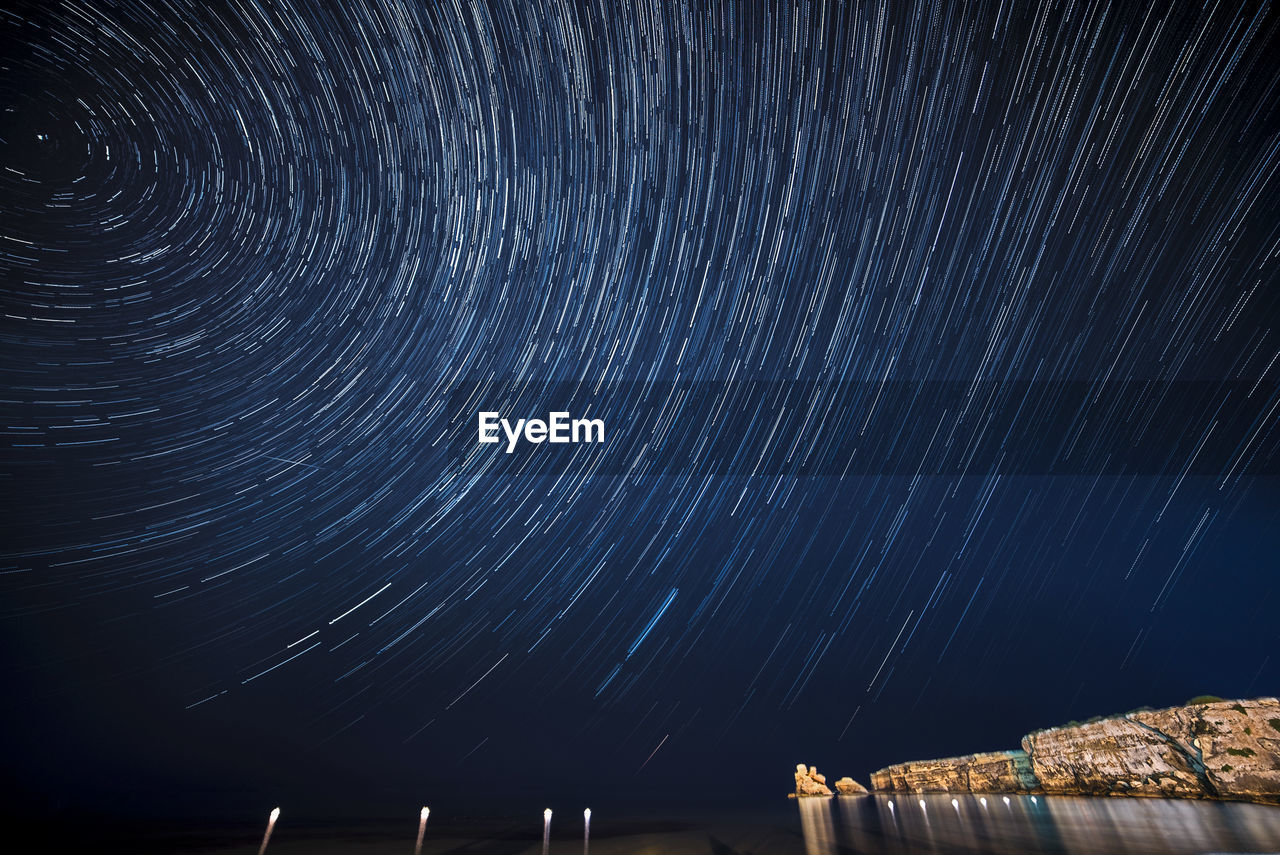 LOW ANGLE VIEW OF SKY AGAINST STAR FIELD AT NIGHT