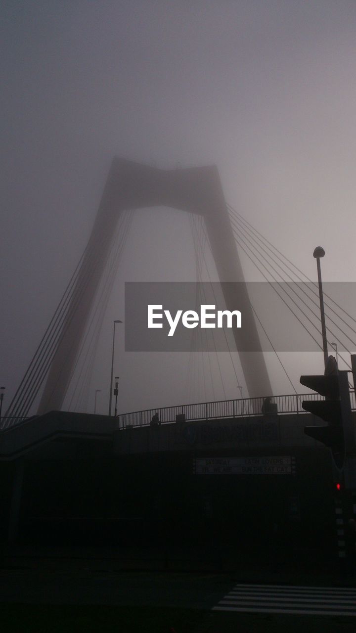 Low angle view of willemsbrug in foggy weather