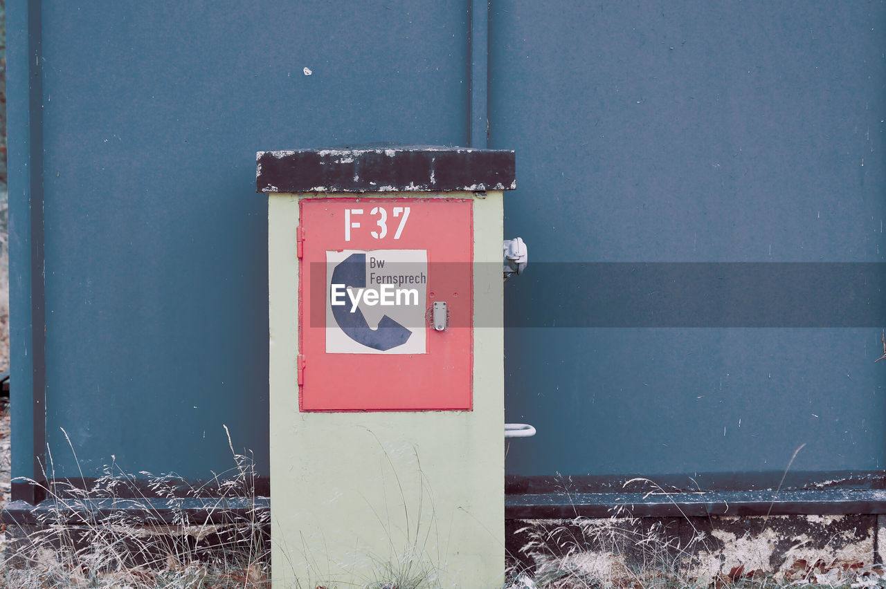 Close-up of military telefon information sign on wall