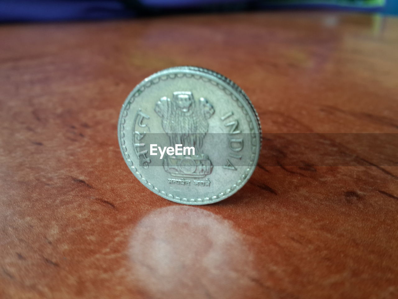 CLOSE-UP OF COIN ON THE TABLE