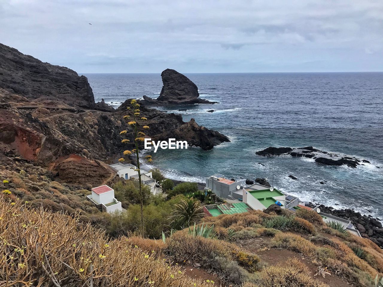 High angle view of rocks on beach against sky