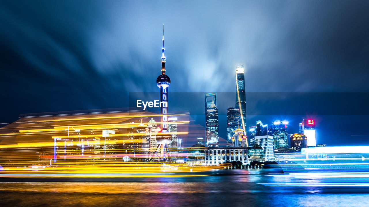 Illuminated buildings against sky at night