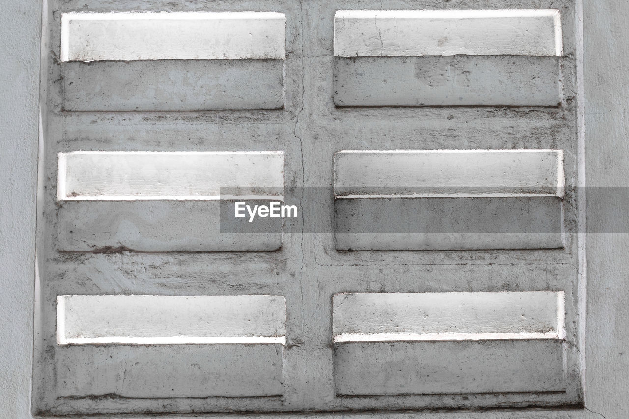 FULL FRAME SHOT OF WEATHERED WALL WITH DOOR