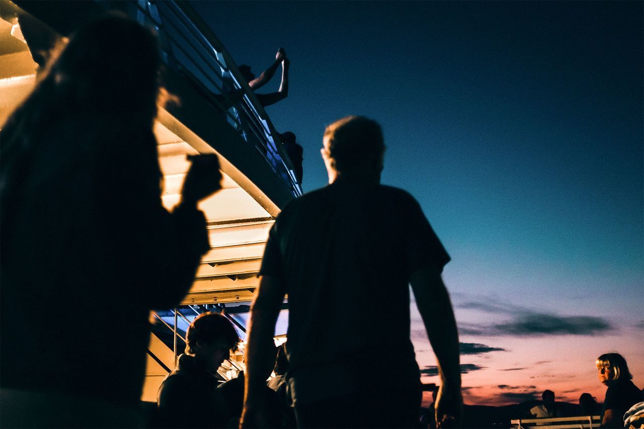 Silhouette people against sky during sunset