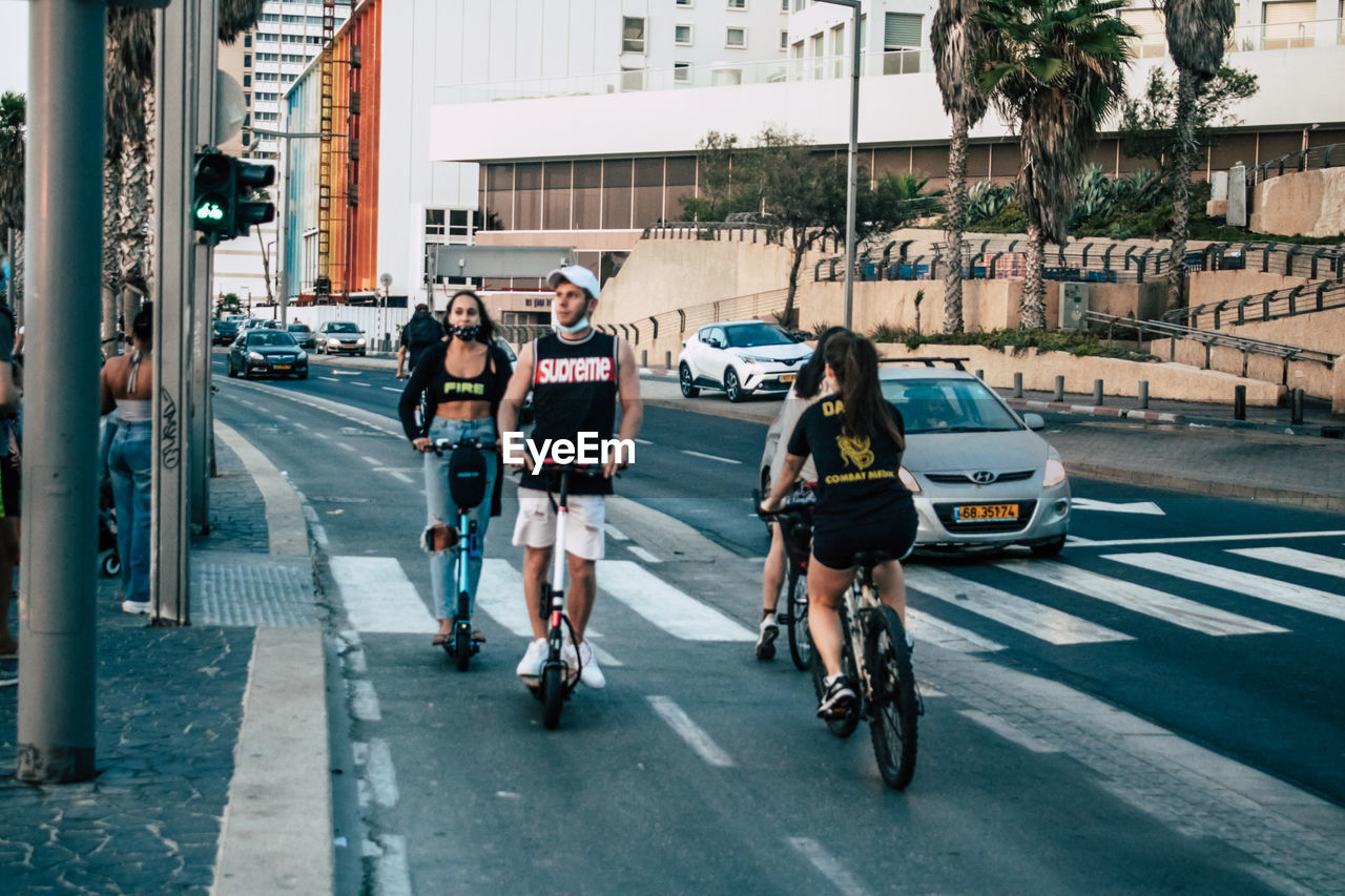 PEOPLE RIDING BICYCLE ON ROAD