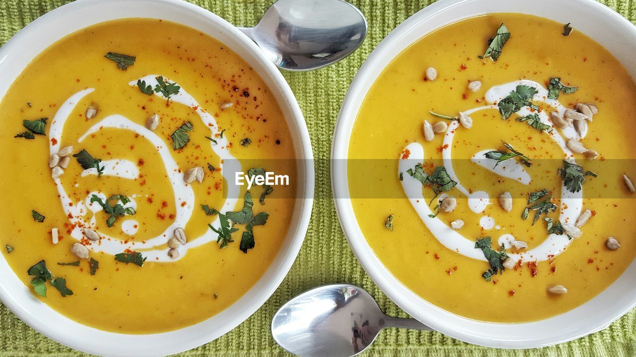 Directly above shot of soup served in bowls on table