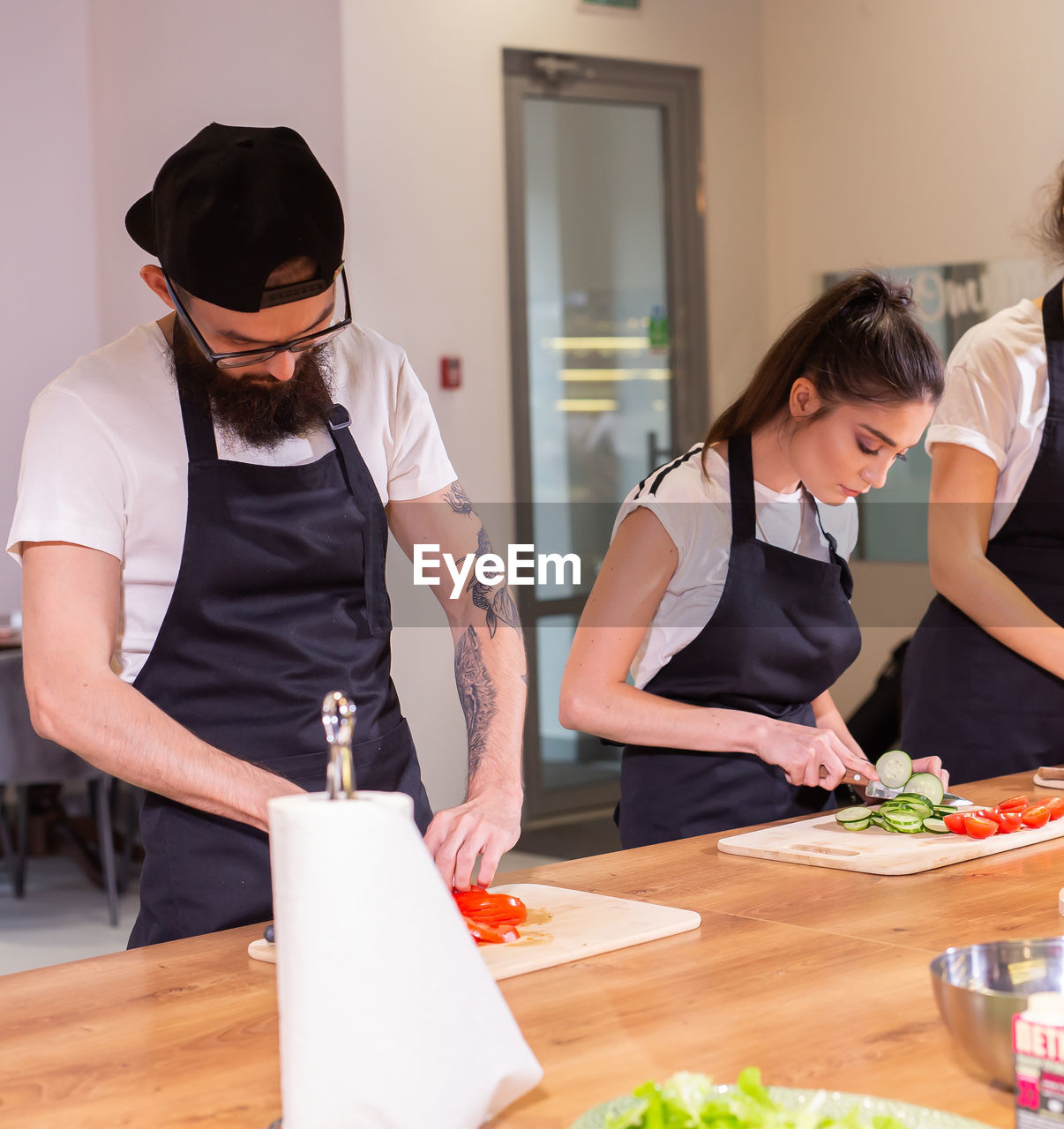 side view of young woman preparing food on table