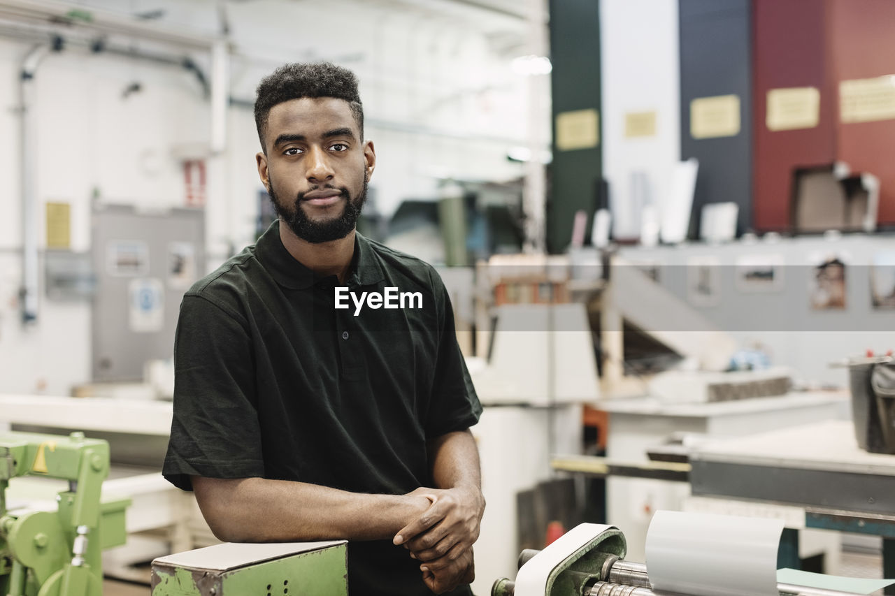 Portrait of confident male student in workshop