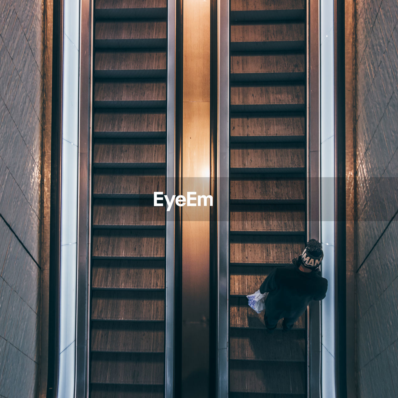 Directly above shot of man on escalator in building