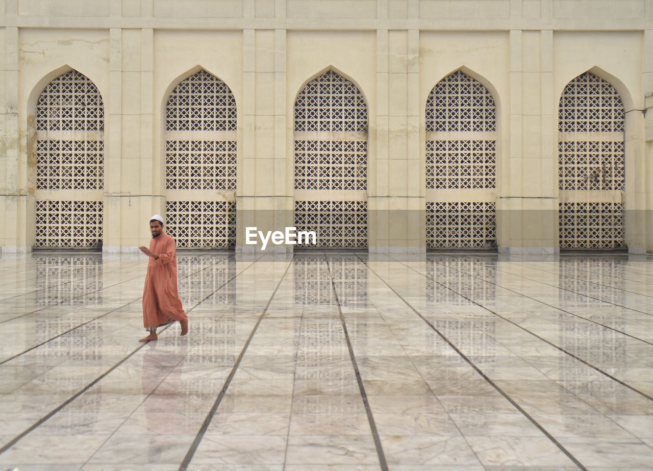 Full length of man walking on floor in mosque