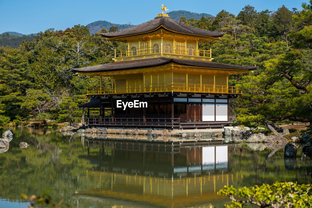 VIEW OF BUILDING AGAINST LAKE